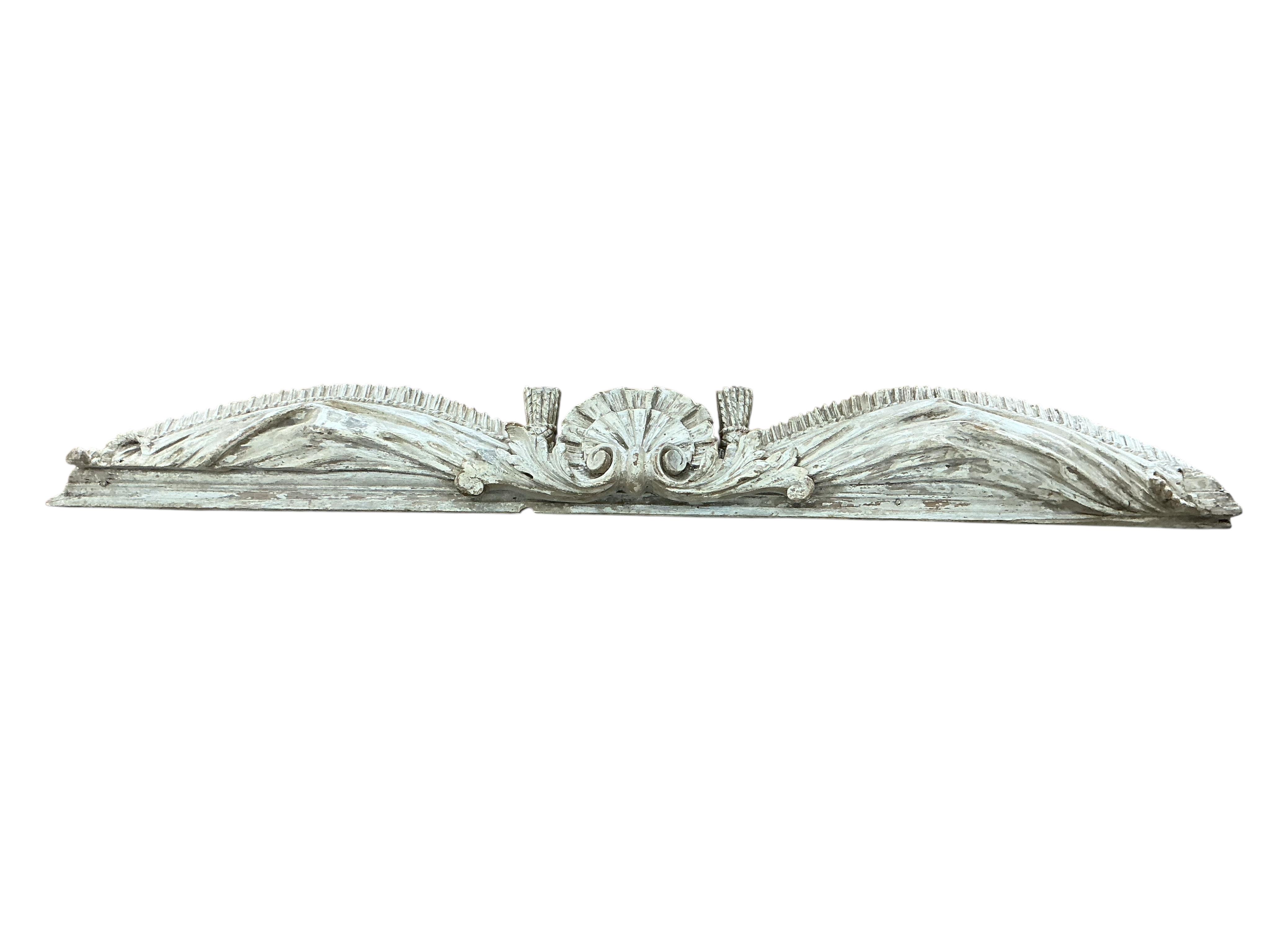 Two cream painted carved wood pediments, largest width 132cm